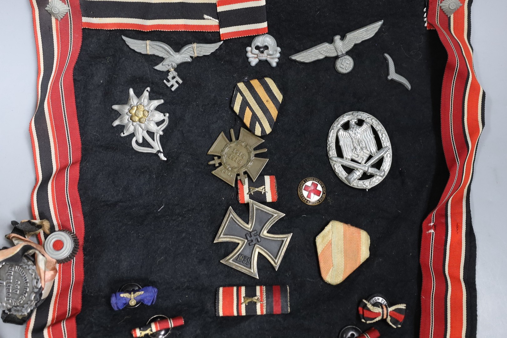 A group over WW1 to WW2 German medals and cap badges and a World War I pair to 2218924 PTE. 1. A. B. Ward. R.A.F. and two compasses